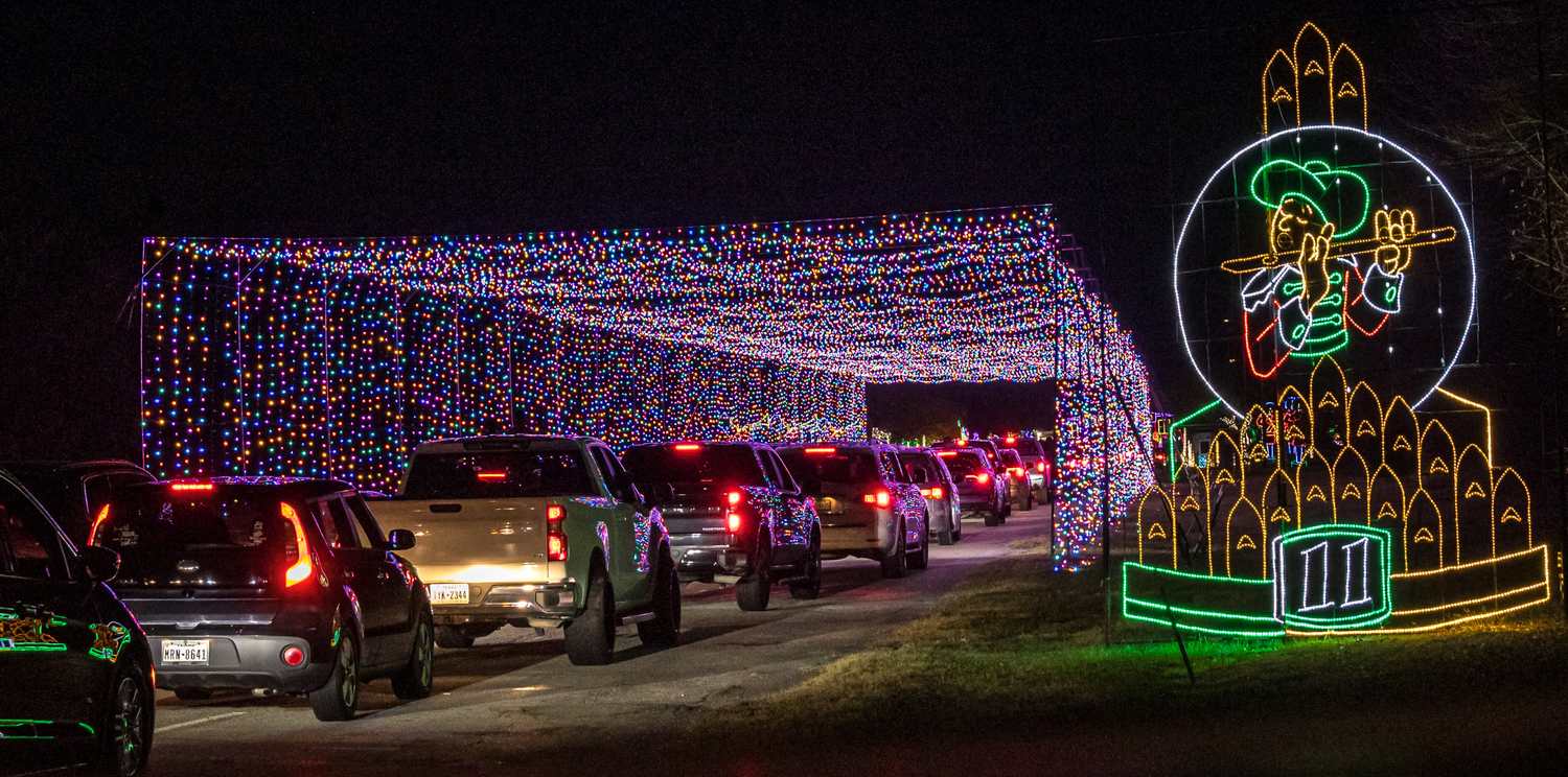 Cars moving slowly through the lit tunnel at Lights of Joy Christmas drive-thru
